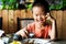 Asian child having lunch at the restaurant