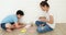 Asian child learning to folding Japanese paper origami with mother