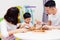 Asian child and parents playing with wooden blocks in the room at home. A kind of educational toys for preschool and kindergarten