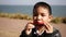 Asian child playing harmonica, mouth organ