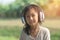 Asian child wearing headphone with bokeh