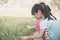 Asian children playing grass flowers in the park