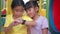 Asian children`s girls using her smart watch device at outside playground.