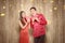 Asian Chinese couple in cheongsam dress holding red envelopes