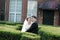 Asian Chinese couple in wedding dress stand in bushes