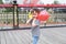 Asian Chinese cute naughty lovely adorable girl play with balloon and have fun outdoor in summer park happy smile walk on street