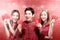 An Asian Chinese family in a cheongsam dress holding red envelopes