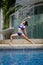 Asian Chinese female Yogi practising by the swimming pool