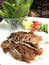 Asian Chinese food cuisine: traditional bbq grilled Beijing duck with fresh chili, cucumber, spring onion and kale vegetable. Duck