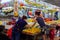 An Asian Chinese fruit seller serving customers at her fruit stall at the Ang Mo Kio wet market in Singapore, Southeast Asia