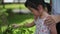 Asian Chinese girl 5 years old plucking flowers nature outdoor