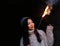 Asian chinese Girl holding sparkler firework with hand at black background . Brunette, looking