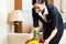 Asian Chinese hotel housekeeper placing fruit