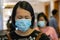 Asian Chinese Lady with medical facemask to Prevention of bacterial infection Corona virus or Covid-19 during walk at shopping