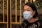 Asian Chinese Lady with medical facemask to Prevention of bacterial infection Corona virus or Covid-19 during walk at shopping