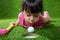 Asian Chinese little girl blowing the ball into a hole