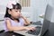 Asian Chinese little girl busy reading mobile phone and laptop