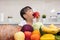 Asian Chinese little girl eating apple infront fruit and vegetable