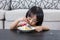 Asian Chinese little girl eating birthday cheese cake