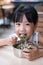 Asian Chinese little girl eating steamed minced pork and rice