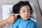 Asian Chinese little girl getting measurement for fever temperature