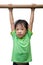 Asian Chinese little girl hanging on horizontal bar