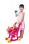 Asian Chinese little girl holding credit card with shopping trolley full of vegetables