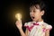 Asian chinese little girl holding a light bulb