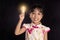 Asian chinese little girl holding a light bulb