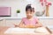 Asian Chinese little girl making dumpling in the kitchen