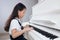 Asian Chinese little girl playing classical piano at home