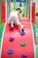 Asian Chinese little Girl playing at mini rock climbing wall