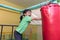 Asian Chinese little girl playing with punching bag