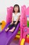 Asian Chinese little girl playing on the slide