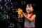 Asian Chinese Little Girl Playing Soap Bubbles