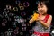 Asian Chinese Little Girl Playing Soap Bubbles