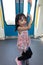 Asian Chinese little girl pole dancing inside a MRT transit