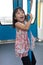 Asian Chinese little girl pole dancing inside a MRT transit