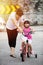 Asian Chinese little girl riding bicycle with mom guide