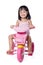 Asian chinese little girl riding a toy tricycle