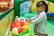 Asian Chinese little girl role-playing at fruits store