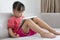 Asian Chinese little girl sitting on the sofa playing digital ta