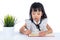 Asian Chinese little office lady writing book on the desk