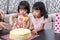 Asian Chinese little sister cutting birthday cake
