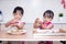 Asian Chinese little sisters making moon cake in the kitchen