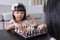 Asian Chinese little sisters playing chess together at home