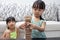 Asian Chinese little sisters playing wooden stacks