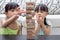 Asian Chinese little sisters playing wooden stacks