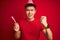 Asian chinese man on birthday celebration wearing funny hat over isolated red background annoyed and frustrated shouting with