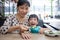 Asian Chinese mother and daughter eating beef noodles